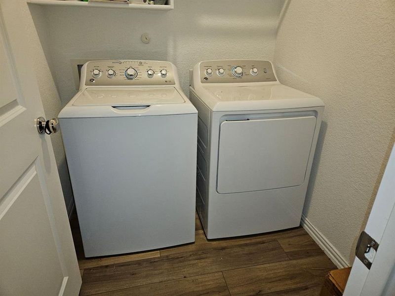 Laundry room featuring separate washer and dryer and dark hardwood / wood-style floors