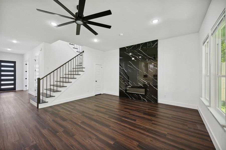 Unfurnished room featuring ceiling fan and dark hardwood / wood-style flooring