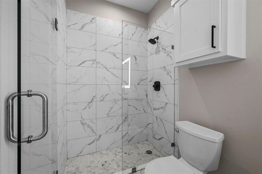 Bathroom featuring toilet and walk in shower