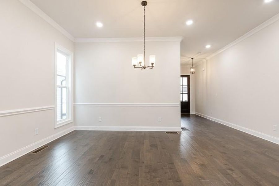 This home features a gorgeous dining room area that is separate yet cohesive with the open kitchen and living space.  Photo not actual home, but previously built Mansfield plan.