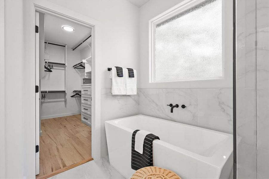 Bathroom featuring a tub and wood-type flooring