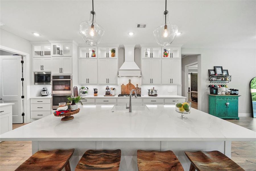 This immaculate kitchen is ready for you to show off your culinary skills. Find gorgeous Quartz countertops and backsplash, tons of cabinetry, sleek stainless steel appliances, a large walk-in pantry and more.