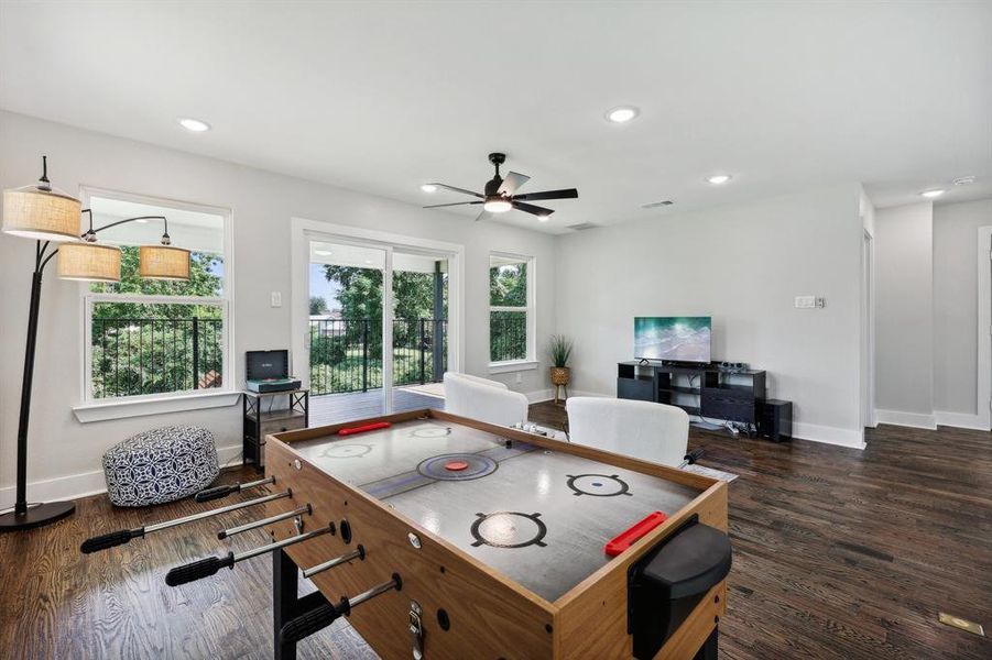 Rec room featuring dark wood-type flooring and ceiling fan