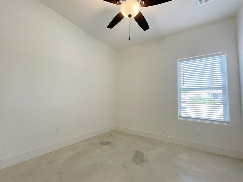 Empty room with lofted ceiling and ceiling fan