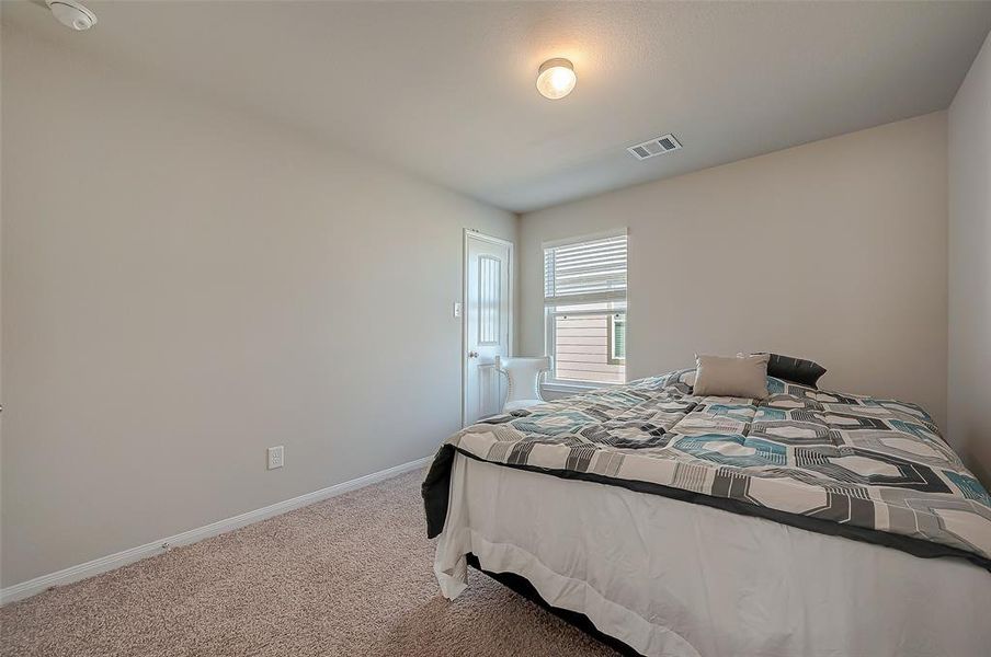 The secondary bedroom is a welcoming space, with enough room for a cozy bed and additional furniture. This bedroom combines comfort and functionality.