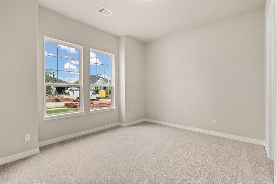 Your secondary bedroom features plush carpet, fresh paint, closet, and a large window that lets in plenty of natural lighting.