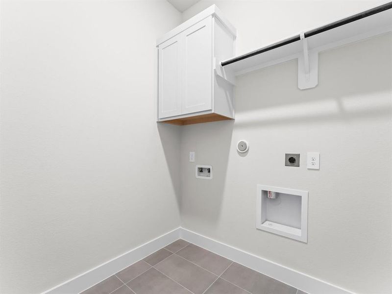 Utility Room with Washer and Dryer Connections, Storage Cabinet, and Hanging Bar.