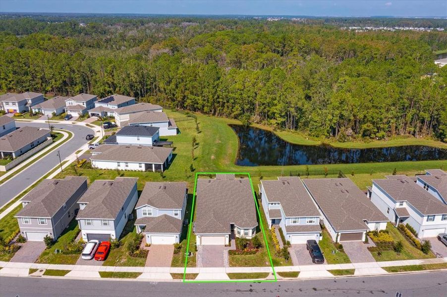 Aerial view of home with conservation area.