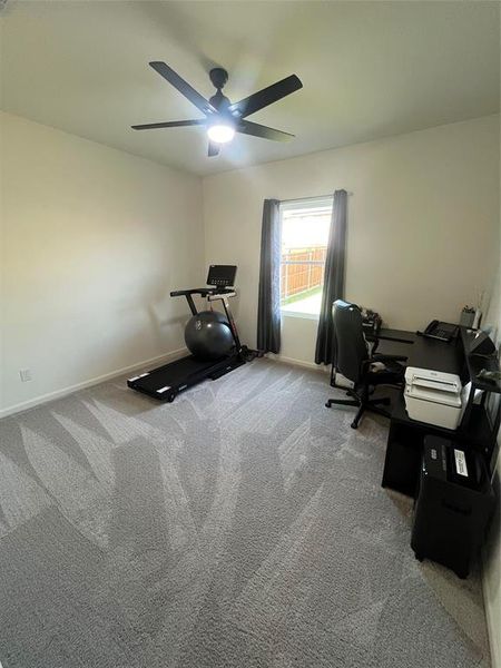 Office area with ceiling fan and carpet floors