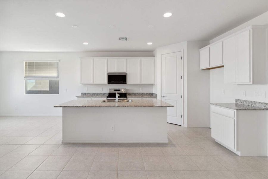 Iris Plan kitchen & great room. Available finishes may vary by community.