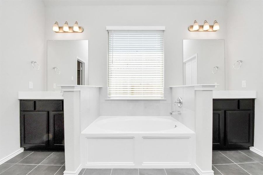 Indulge in relaxation with the standing shower in the primary bath surrounded by elegant tiles, the steamy ambiance and soothing lighting create a spa-like retreat