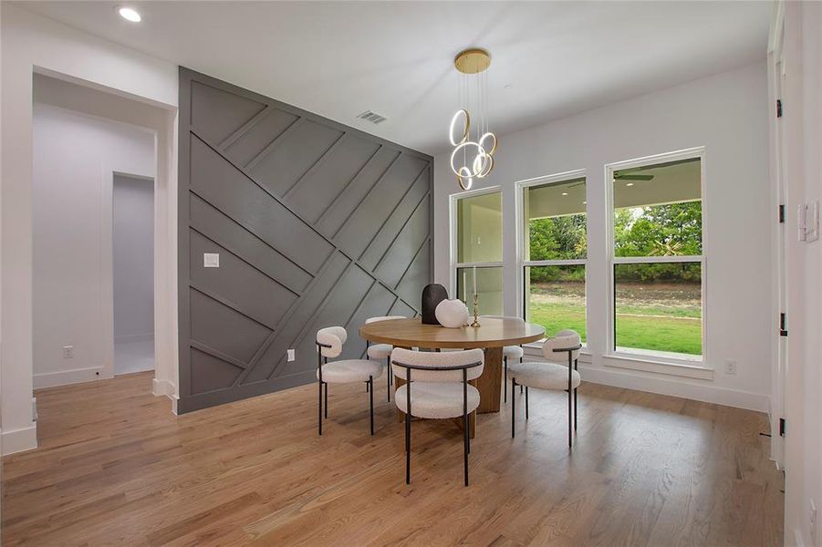 Dining room with a chandelier and light wood-type flooring