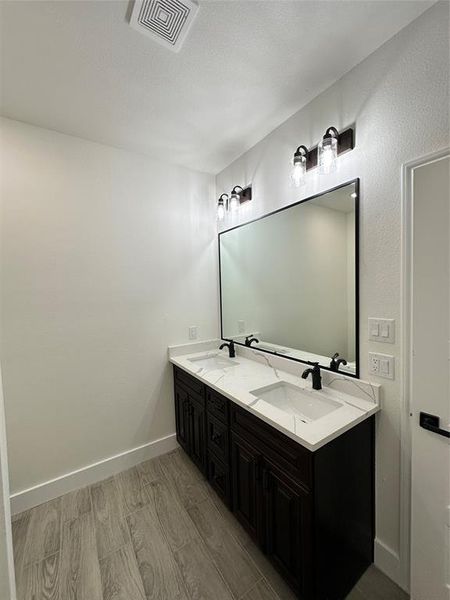 Bathroom with hardwood / wood-style floors and vanity