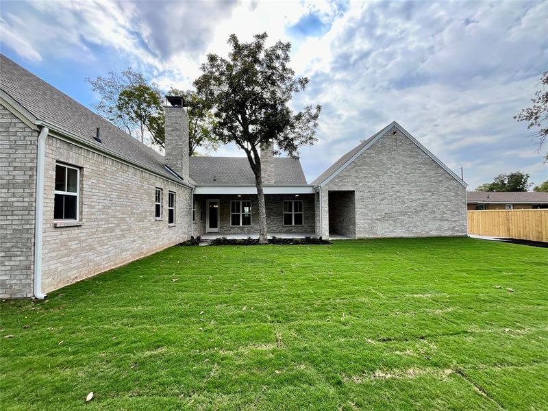 Back of house featuring a yard