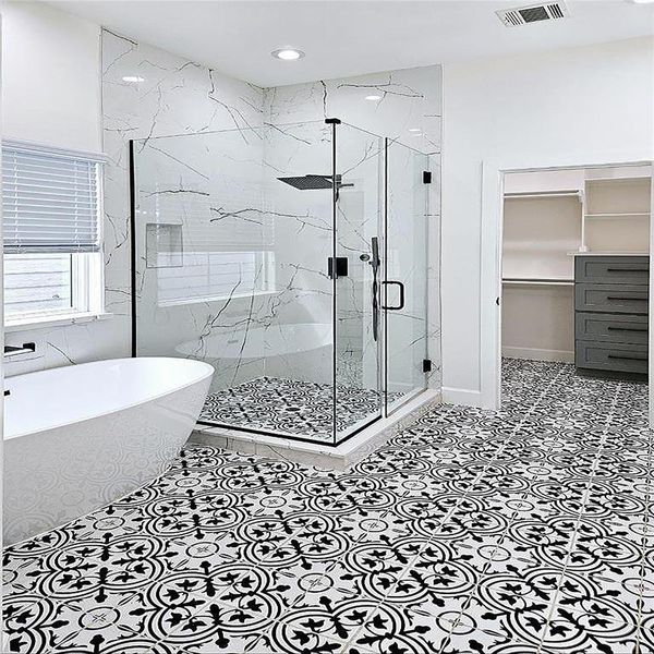 Another view of the primary bathroom, the floor design bouncing against the quartz shower wall is impressive.