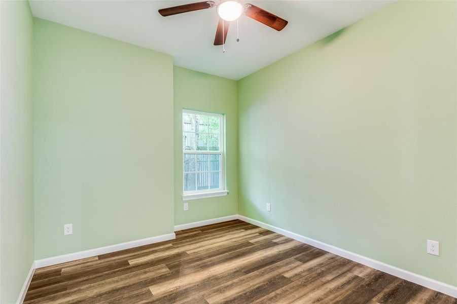 Unfurnished room featuring wood-type flooring and ceiling fan