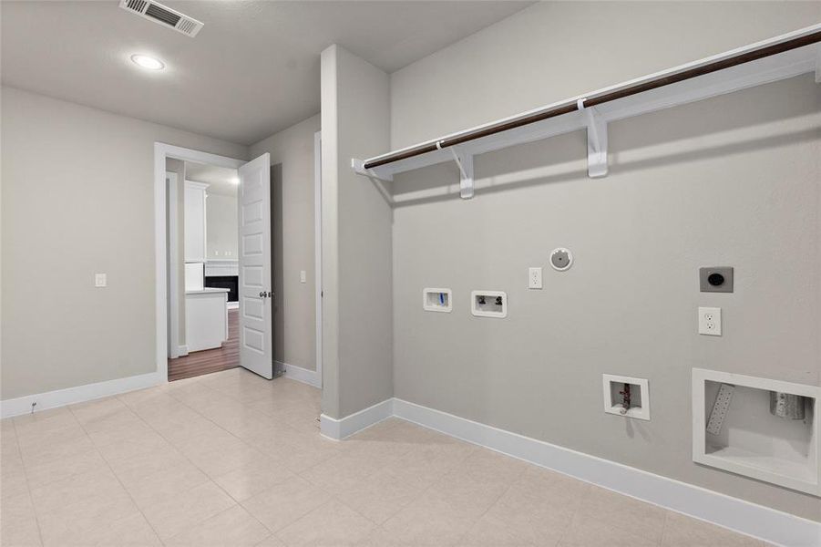Located just off the kitchen, this HUGE laundry room allows for plenty of room to complete laundry tasks efficiently. There is space not only for a washer and dryer, but also a full-size refrigerator.