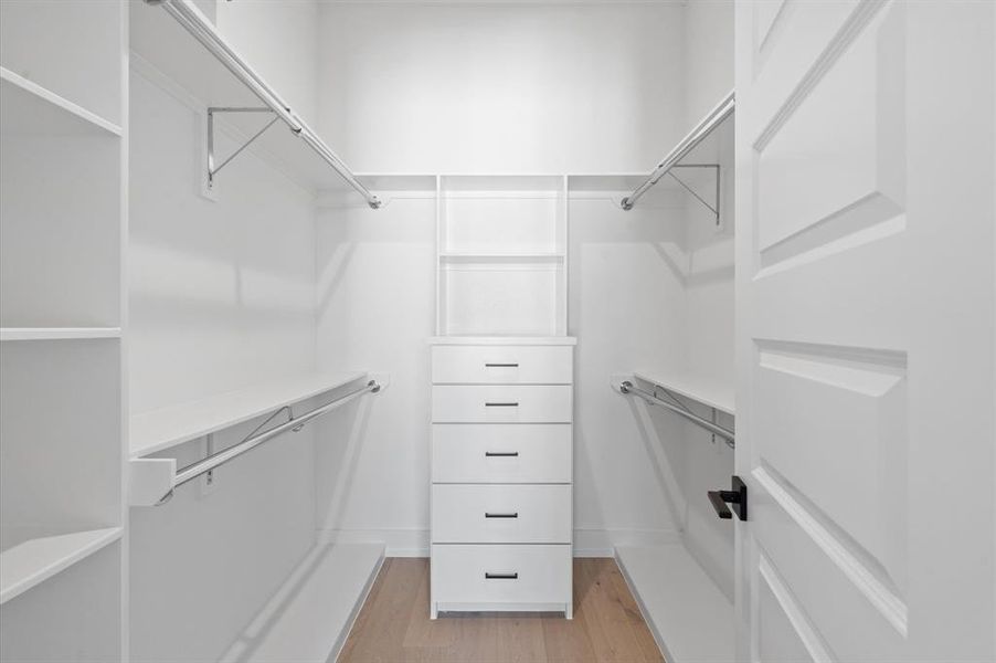 Spacious primary closets with custom cabinetry.