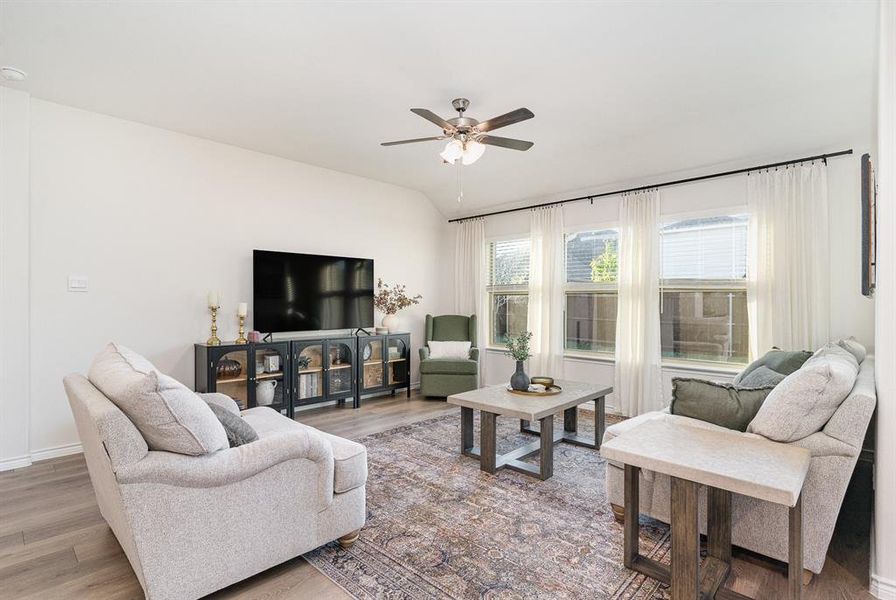 Living room featuring hardwood / wood-style floors and ceiling fan