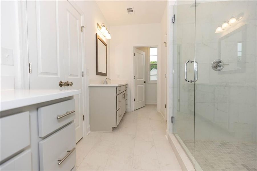 The primary bathroom have separate vanities and give space for each party in the mornings. Not actual home. Photos of previously built Stockton plan.