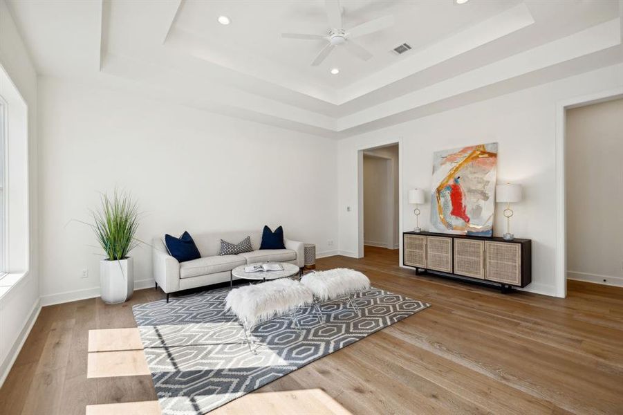 Second floor game room with tray ceiling, ceiling fan and engineered white oak hardwood floors serves as the central space to all 4 upstairs bedrooms, each with their own private bath.