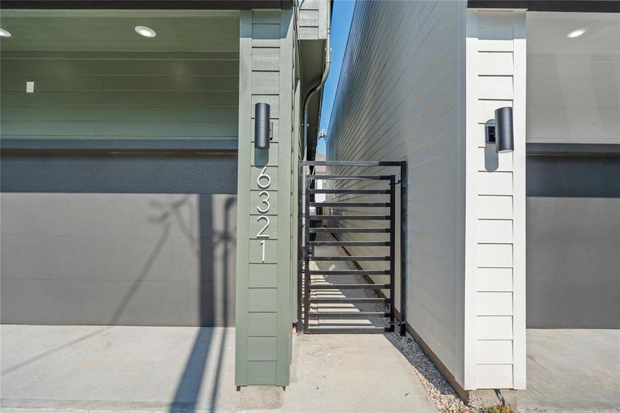 Enjoy the convenience of a private gate leading to both the front door and backyard, providing security and easy access to your home's main entrances.
