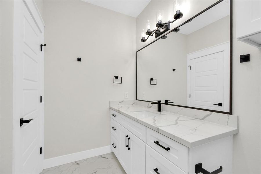 Elegant en-suite bathroom in second primary room, blending style with functionality.