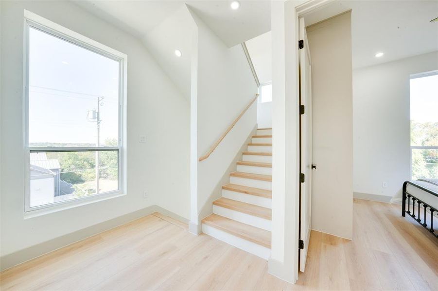 Stairs featuring hardwood / wood-style flooring