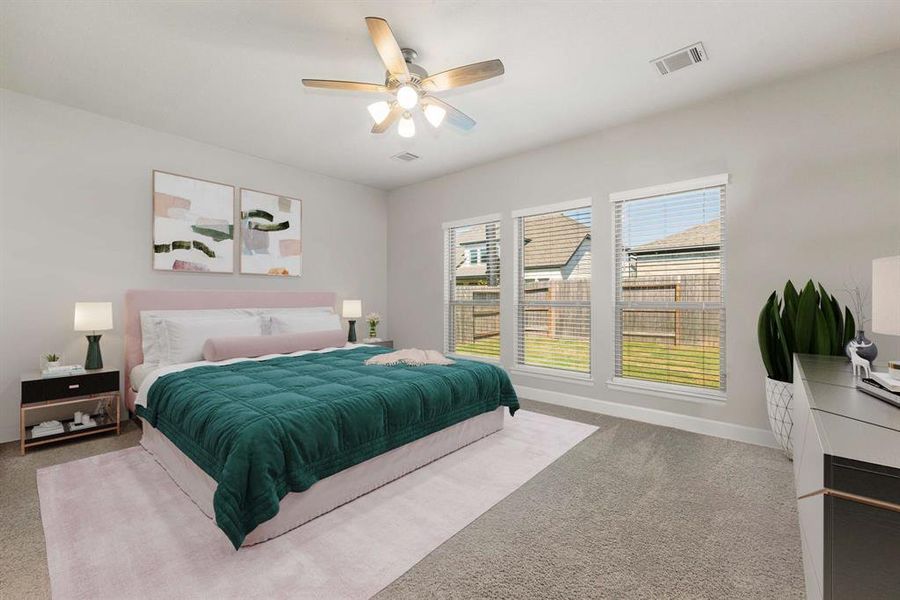 What a wonderful place to come home to, this stunning primary suite greets you with plush carpet floors, a warm neutral paint, high ceiling, ceiling fan with lighting, lovely windows with blinds allowing in natural light brightening up this spacious primary bedroom, with extra space for a seating area.