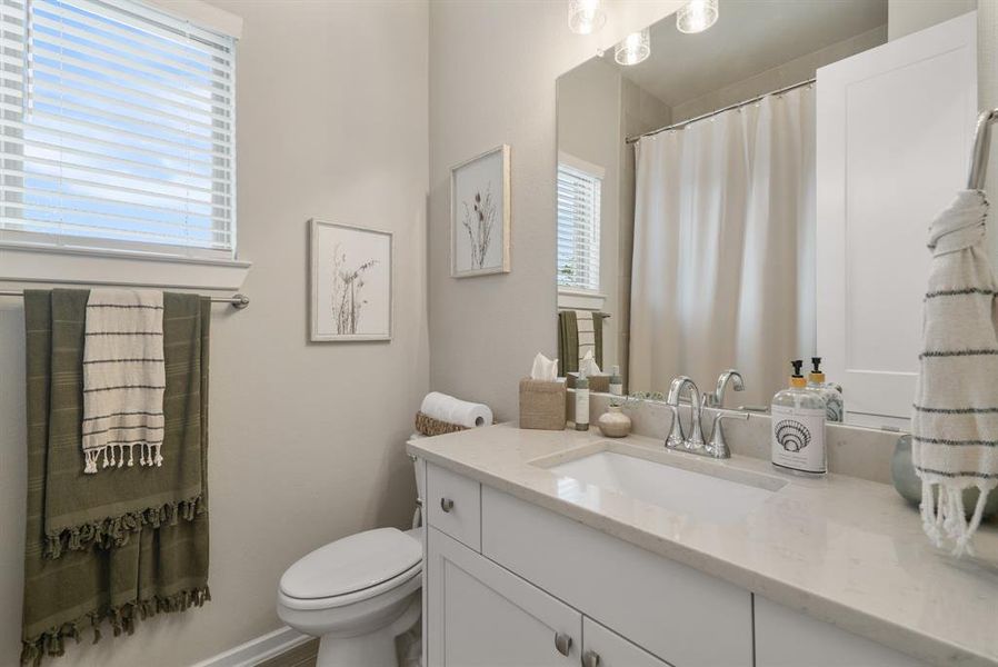 Full bathroom in between two secondary bedrooms.