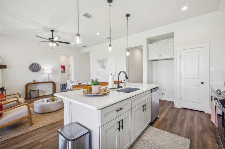 Kitchen featuring hardwood / wood-style flooring, tasteful backsplash, white cabinetry, and range with electric cooktop