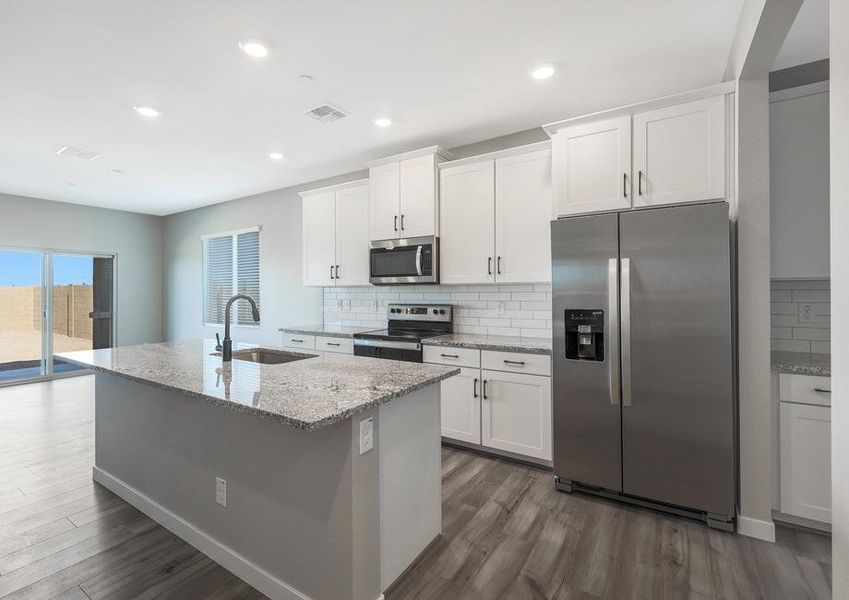 Chef-ready kitchen with white cabinets and granite countertops.