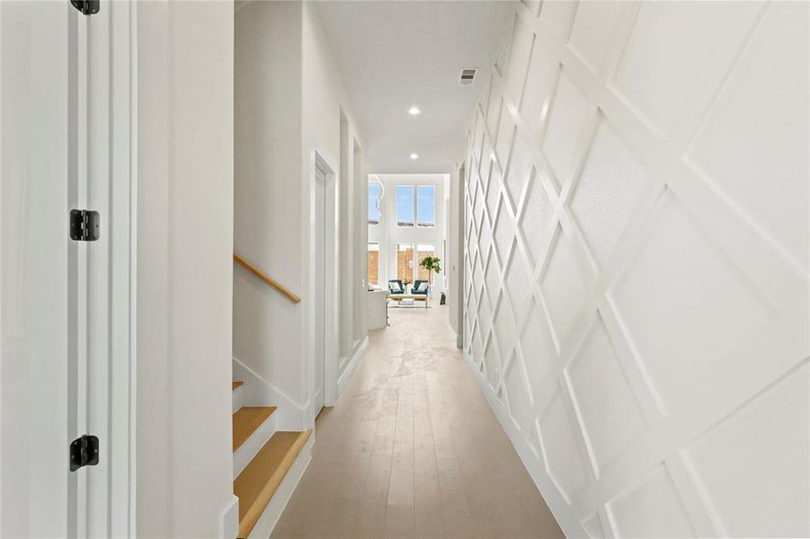 Hallway with light hardwood / wood-style flooring