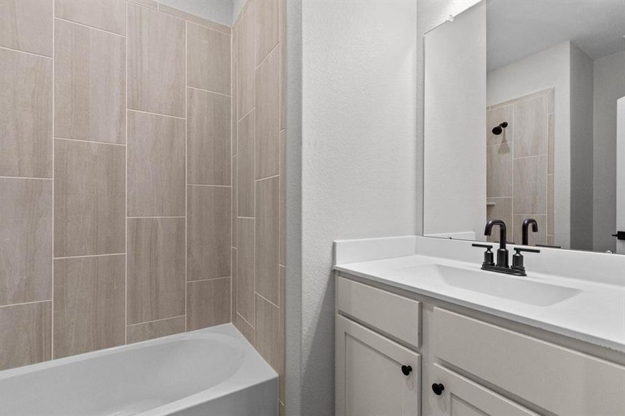 The secondary bathroom, located between the two additional bedrooms.