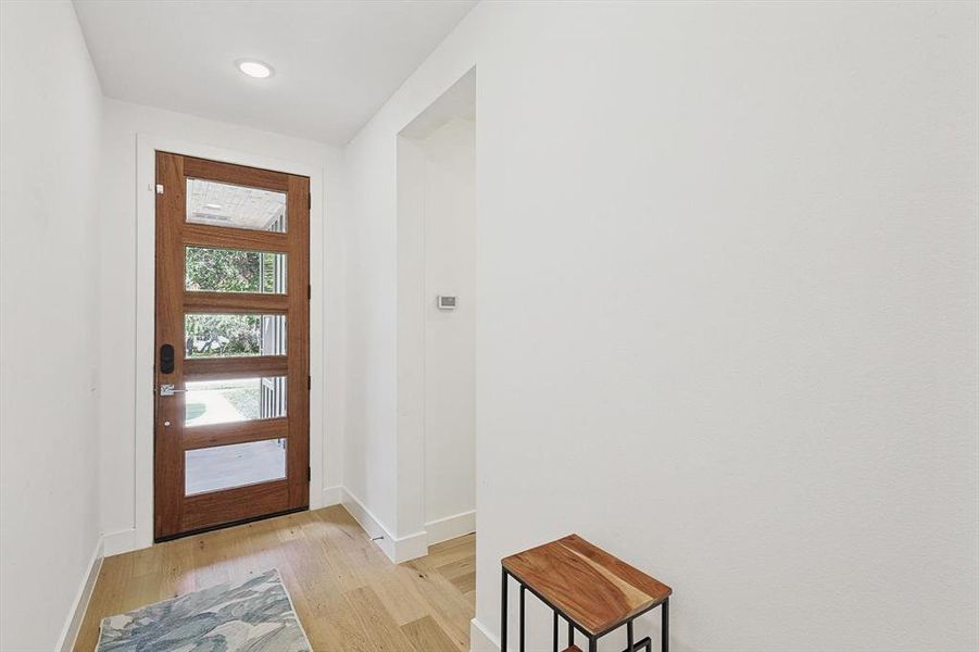 Doorway to outside with light hardwood / wood-style floors