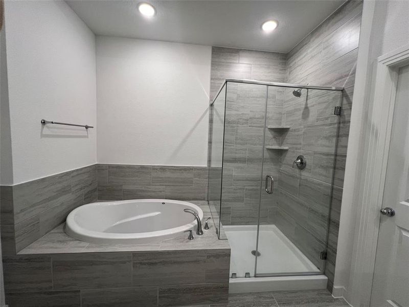 Bathroom featuring tile flooring and separate shower and tub