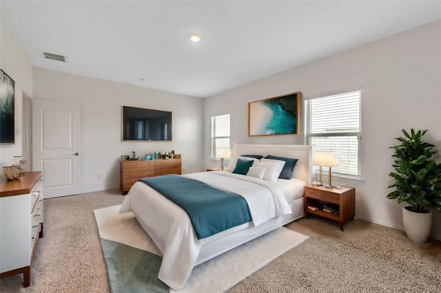 The primary bedroom on the first floor overlooks the backyard and is large enough for a king sized bed. Two nice sized windows bring in plenty of natural light into the room.