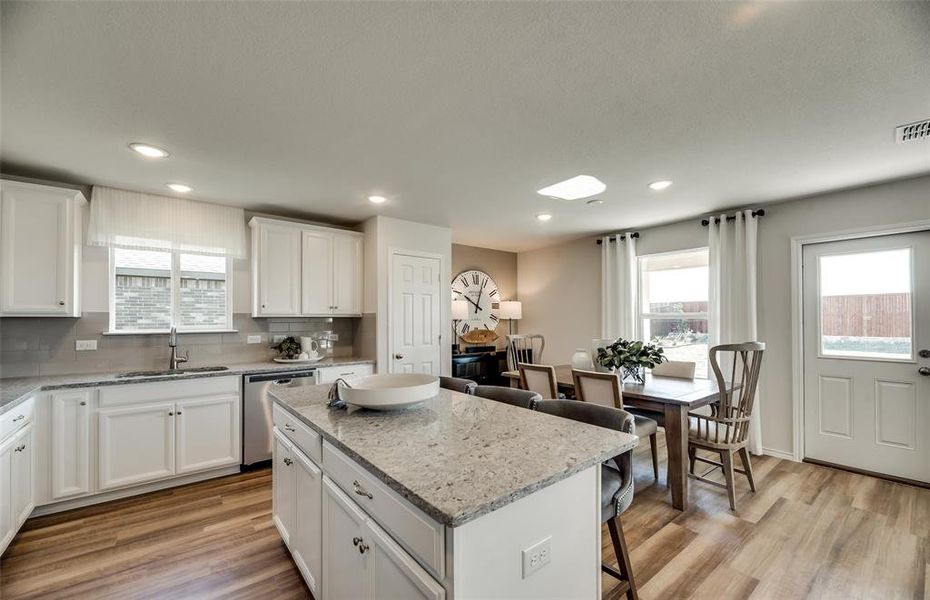 Kitchen with abundant cabinet space and eat-at bar top island *Photos of furnished model. Not actual home. Representative of floor plan. Some options and features may vary.