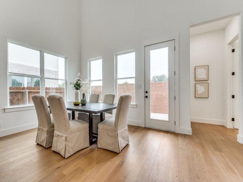 Dining space with a wealth of natural light and light hardwood / wood-style floors