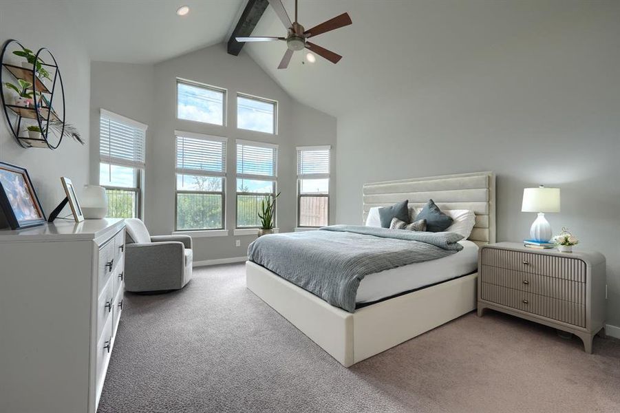 Bedroom featuring beamed ceiling, carpet floors, and ceiling fan
