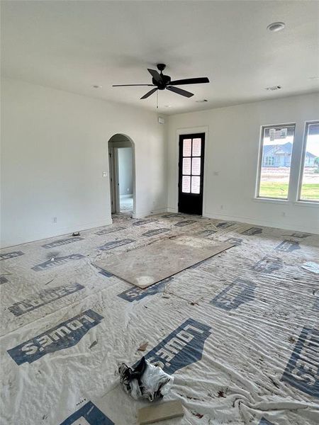 Empty room with a healthy amount of sunlight and ceiling fan