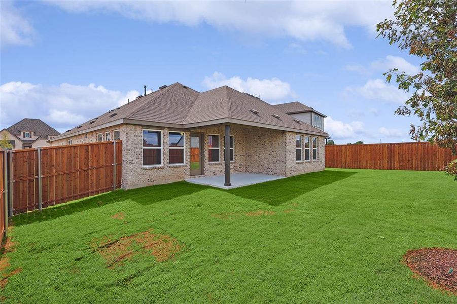 Back of property featuring a patio and a yard