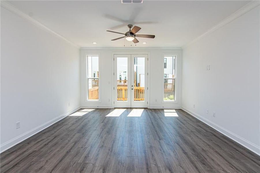 Living Room with big windows leading to an Wooden Deck . Not the actual unit previously built