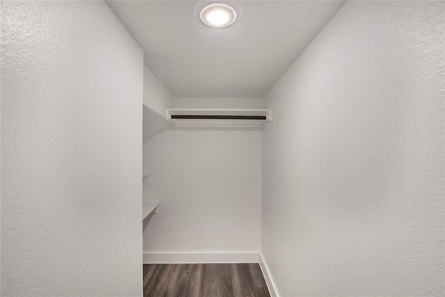 Walk in closet featuring hardwood / wood-style floors