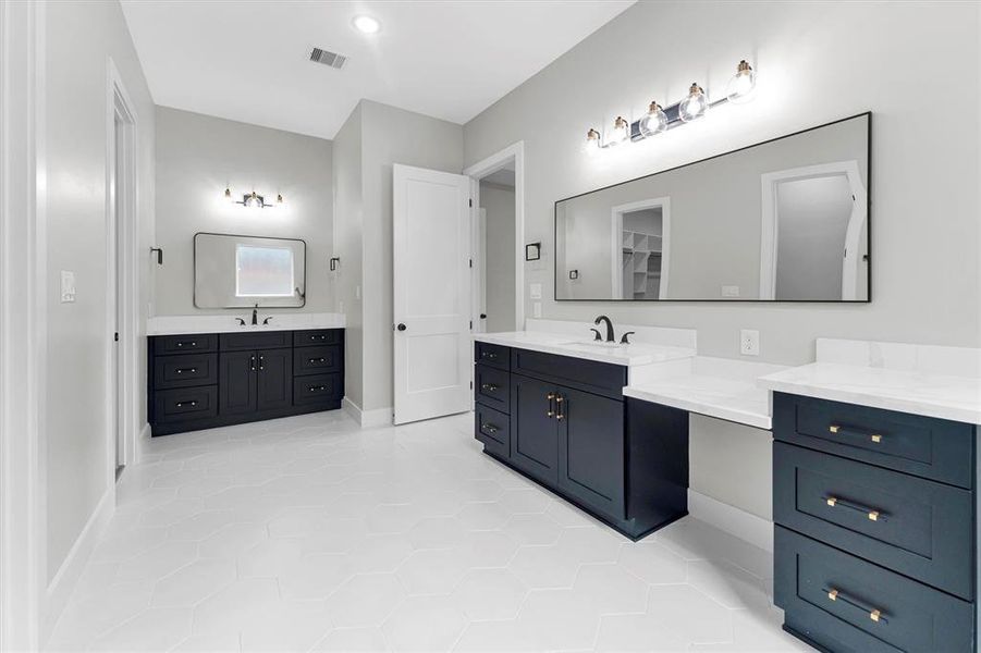 Large primary bath includes dual vanities with soft-close drawers and separate sinks