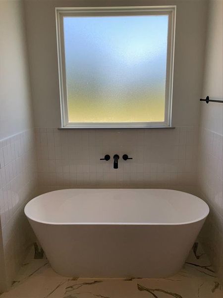 Bathroom with tile walls and tile flooring
