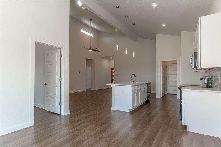 Primary bedroom and ensuite bath off of dining/kitchen area