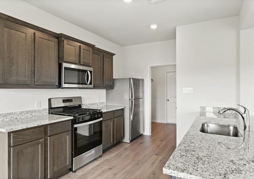 The kitchen has sprawling granite countertops.