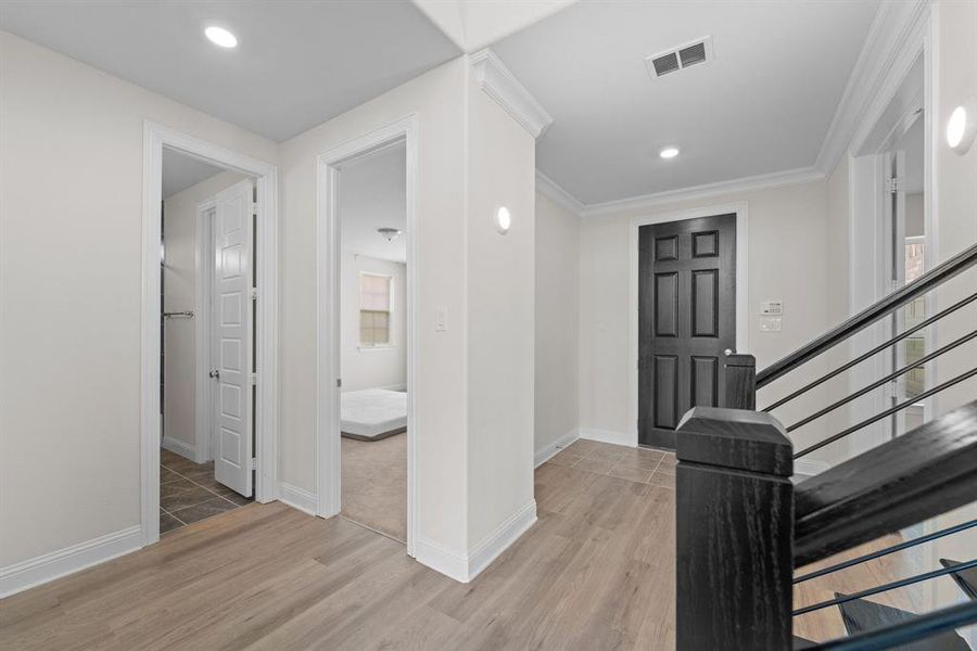 Foyer entrance with hardwood / wood-style floors and crown molding