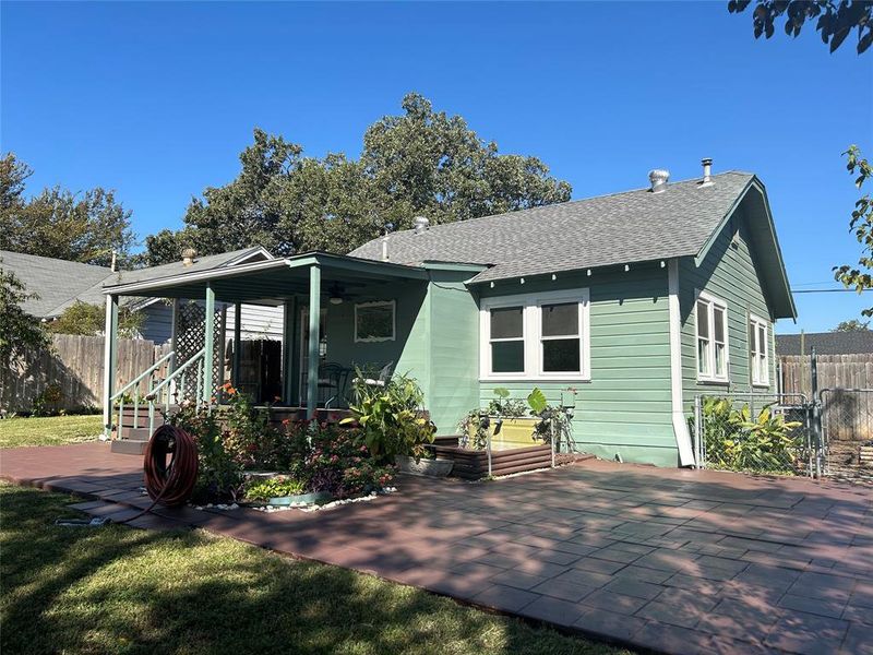 Rear view of property featuring a patio and a lawn